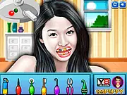Jun Ji Hyun at Dentist game screen showing the celebrity in a dentist chair and tools for teeth cleaning and drilling