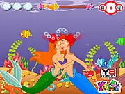 My Dear Mermaid Kiss free online game screenshot showing a mermaid couple kissing underwater while a curious fish swims nearby on PlayArcadeHub.