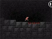 The hero character running and jumping over a spike pit inside a dark, ancient-looking cave with stone walls in The Lost Temple retro platformer game
