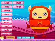 Valentine Monster Creator game screen showing a cute, customizable monster with heart-shaped antennae, big eyes, and pink fur, surrounded by various monster parts to choose from.