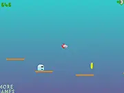 Skating Blocks free online game screenshot showing the character jumping to collect a gold coin over a brightly colored obstacle block
