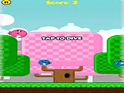 Screenshot of Ballsy Bird game showing the small yellow bird falling toward deadly spikes while two blue birds fly nearby for bouncing.