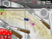 Screenshot of Model Car Racing free online game, showing small model cars racing on a track with a power-up icon.