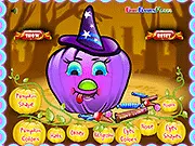 A Halloween Pumpkin Design game screen showing a carved pumpkin with spooky eyes and mouth, surrounded by festive Halloween decorations.