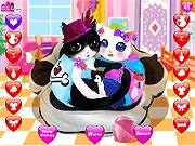 The game screen for Heart Cats Dress Up Free, showing an adorable cartoon cat with heart-shaped features, wearing a custom outfit of clothes and accessories.