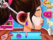 A cartoon screenshot of the Baby Ear Doctor game showing a little girl sitting in a doctor's chair while medical instruments are being used on her ear.