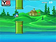 Flappy Doraemon online game with the blue robot cat flying between green pipes to collect cakes