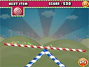 Play Candies Bout free online skill game balancing a seesaw with different candies
