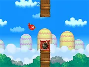 Gameplay screen of Red Flappy Bird 2 showing the red bird navigating between block towers and a dangerous black bomb.