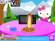 Hello Kitty Cooking Touchdown Pizza free online game screenshot showing Hello Kitty in a kitchen with ingredients for making pizza