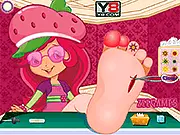 Strawberry Shortcake Foot Doctor game screen, treating an injured foot with medical tools, children's caring game online