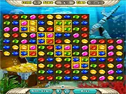 Screenshot of Atlantis Jewels Match 3 game showing colorful jewels being matched underwater with stone slabs needing to be cleared, free online puzzle game.