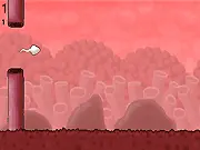 The challenging and humorous free arcade game Fallopian Bird, showing the sperm character attempting to navigate a narrow gap.