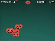Screenshot of the Pumpkin Hunter Clicker Online game showing a computer cursor aimed at several large, smiling orange pumpkins scattered across a dark background.