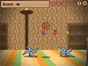 Screenshot of the Rolling Tomato Rescue online game showing Bouille the Tomato rolling across a wooden kitchen table to save other vegetables
