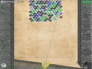 Screenshot of Coba online game showing a stone ball being launched towards clusters of colorful stone balls near a wall-mounted key icon.