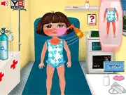 Dora Sunburn Care game screen showing Dora in a hospital bed with a player treating her red, sunburned skin with an ice pack and medical cream