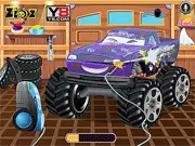 Gameplay screen of Monster Truck Car Wash showing a large, colorful monster truck being cleaned with soap and a brush at a car wash station