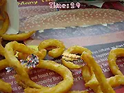 Save the Cheeseburger game image showing a cheeseburger surrounded by flying insects and defensive barriers