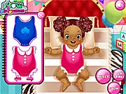 The 'Little Baby Care' game screen showing a happy baby with a selection of new clothes and diapers nearby, ready for the next care step.