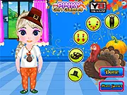 Gameplay screenshot of the free online makeover game Baby Elsa Thanksgiving Makeover showing Baby Elsa smiling in a beautiful holiday dress and sparkling glittering jewels.