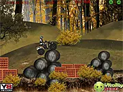 Screenshot of a quad bike (ATV) mid-air jump over a wooden ramp in the forest level of Forest ATV Challenge online game