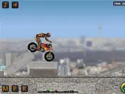 Mototrial Germany online game image showing a trial motorcycle balancing on a rocky, steep obstacle in a forest setting
