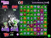 Elsa and Anna from Frozen in a Halloween-themed match-3 puzzle game with monsters and skulls.