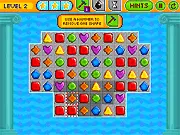 Screenshot of the Pixel Crush Mania match 3 puzzle game interface showing colorful pixelated blocks and an ongoing match being made. Play this free retro game online.