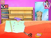 Elsa Tailor Fashion Design free online game showing Queen Elsa creating a new stylish dress with sewing tools and fabric