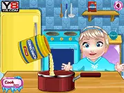 Baby Elsa Ice Cream Cooking game showing the character mixing ingredients to make homemade dessert online