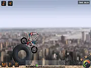 A dirt bike racer performing a precision jump over a challenging obstacle on an off-road track in the free online game Mototrial USA