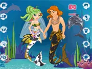 Marry Me Under the Sea game screen showing a mermaid and merman couple being dressed in colorful scales and wedding attire near coral reefs