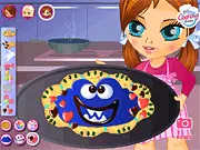 Monster Cookie free online puzzle game featuring a large, talking dessert covered in candy and frosting