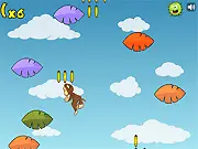 Bananaz! online game screenshot - happy monkey jumping on green leaves to collect yellow bananas