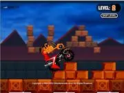 Screenshot of India Adventure game showing a biker riding a dirt bike up a very steep, rugged dirt road against an Indian-themed backdrop.