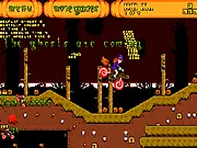 Halloween Motorbike free online game screenshot, a dirt bike performing a mid-air flip over a spooky, obstacle-filled track