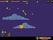 Gameplay screenshot of the Halloween Pumpkin Launch 2 game showing a catapult and a launched pumpkin flying toward a structure of Halloween characters