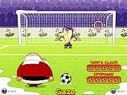 Gameplay screenshot from Xmas Penalties Online showing a football player taking a penalty shot on a snow-covered pitch against a goalie in a festive, winter-themed setting.