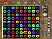 Gameplay screen of Transmute Alpha, a match-3 puzzle game showing colorful gems on a grid with mana bars and spell icons