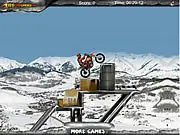 Freezing Rider online game screenshot showing a motorcyclist performing a stunt on an icy, obstacle-filled winter course.