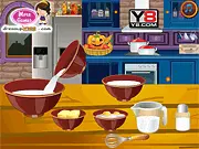Screenshot of the Candy Bar Cupcakes Cooking game showing a finished cupcake frosted with white icing and topped with chopped chocolate candy bars.