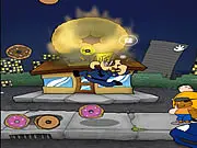 Donut Get! game screen showing a pixelated Police Officer Brown standing on a city street, looking up at a burning building as donuts and other objects fall toward him