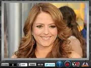 Screenshot of Annie Mumolo Image Disorder puzzle game, showing scrambled tiles of a photo of the actress that need to be rearranged. Play free online.