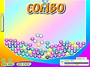 Trinigo game screen showing a cannon aiming a red ball at a cluster of green, blue, and red balls on the board - Play free online match-3 puzzle.