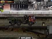 Screenshot of the Heavy Loader 2 free online game showing an old yellow truck with an attached crane attempting to move toxic barrels over a rough, mountainous road