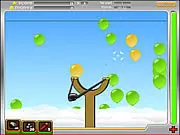 Airborne Pro free online arcade game screenshot showing a slingshot on the ground aimed at a cluster of colorful, floating balloons in the sky.
