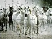 Screenshot of the White Horse Jigsaw online game showing a scattered puzzle over the image of a majestic white horse running.