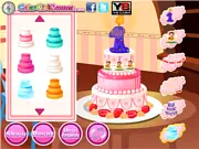 Screenshot from Baby's First Cake game showing a brightly decorated, three-layer birthday cake with candles and colorful sprinkles.