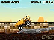 Mega Dump Truck game screenshot showing a large yellow truck driving over rough, rocky terrain with a load of rocks, play free online transport game